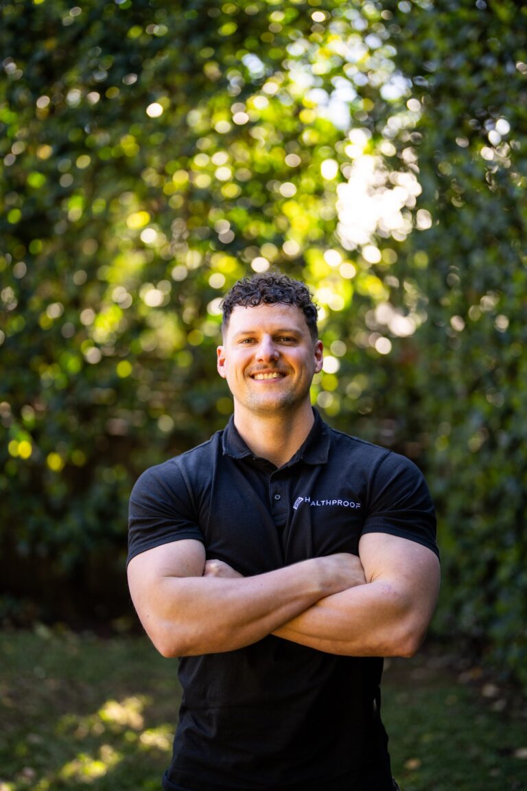 Corey Biczo, Managing Director and Co-Founder of Healthproof, standing outdoors in a Healthproof shirt