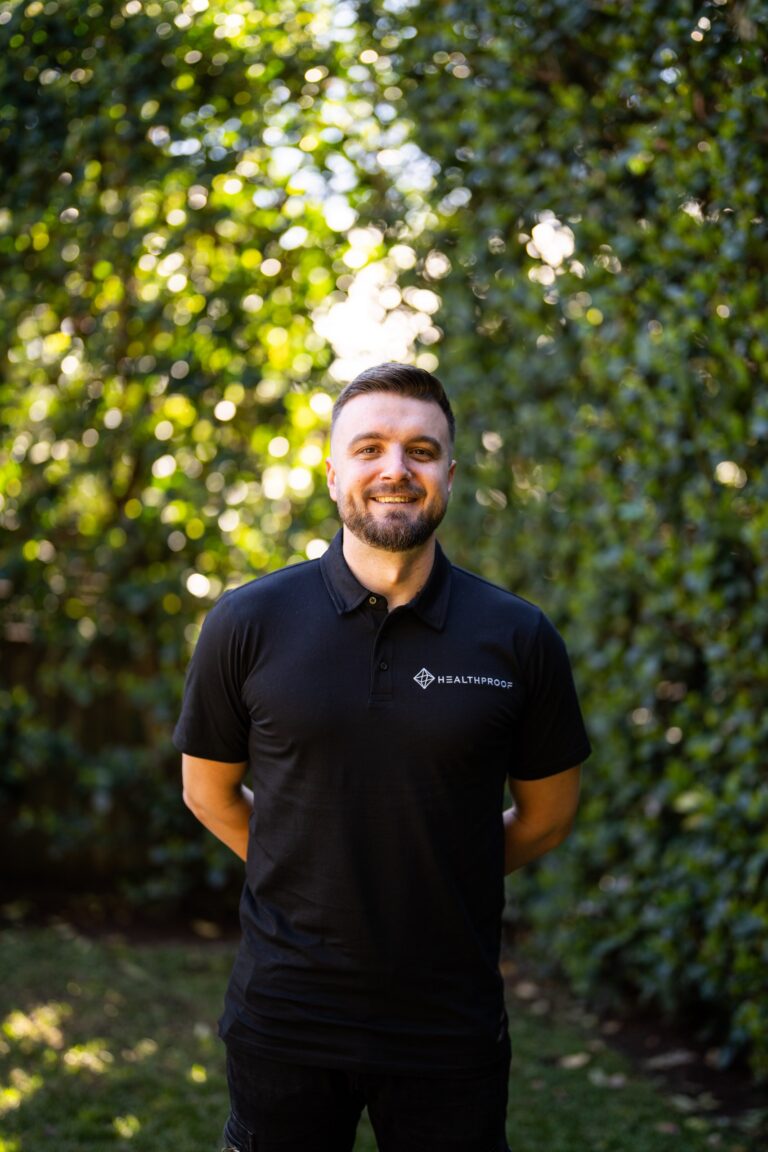 Stephen Brush, Director and Founder of Healthproof, standing outdoors in a Healthproof polo shirt