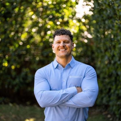 Corey Biczo, Co-Founder and Managing Director of Healthproof, standing outdoors