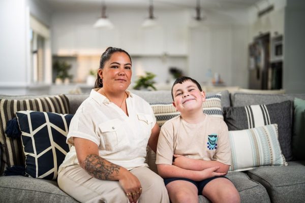 Healthproof occupational therapist sitting with a young client on a lounge
