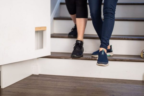 Client practising stair climbing during a home physiotherapy session