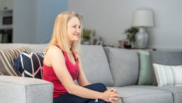 Healthproof physiotherapist talking with a client in her living room