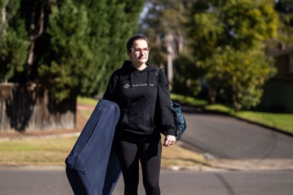 Healthproof clinician walking to a home visit in a suburban street