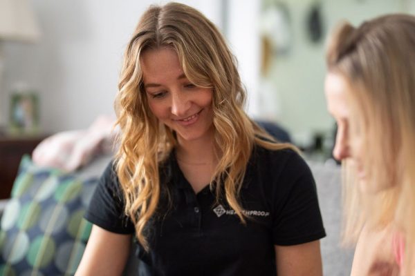 Healthproof speech pathologist working with a young client at home