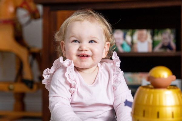 Toddler playing with a spinning toy during a speech pathology session